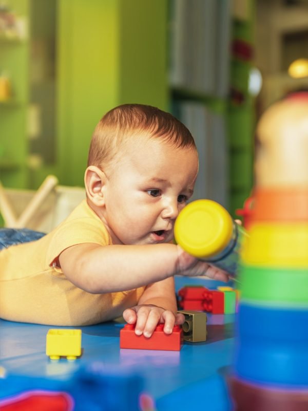 happy-baby-playing-with-toy-blocks-in-the-kindergarten-.jpg